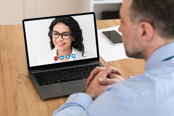 Workers having online discussion during video call at home