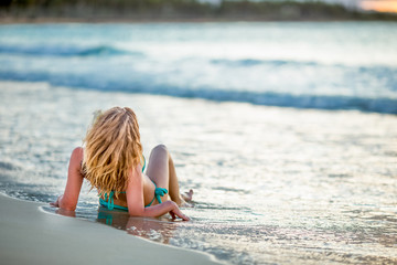 Woman enjoying sunny day on the tropical caribbean sandy beach landscape with turquoise sea and blue sky 