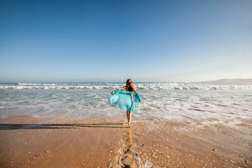 Woman enjoying sunny day on the tropical caribbean sandy beach landscape with turquoise sea and blue sky 