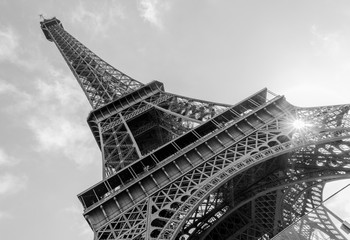 Fototapeta na wymiar Low angle of the Eiffel tower in Paris, France / Black and white
