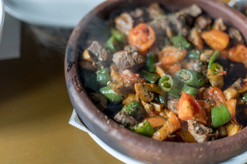 Beef meat with vegetables in casserole stew - Turkish delicious güveç