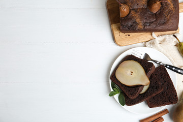 Flat lay composition with tasty pear bread on white wooden table, space for text. Homemade cake