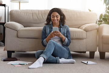 Black Girl Listening Favorite Song On Smartphone While Studying At Home