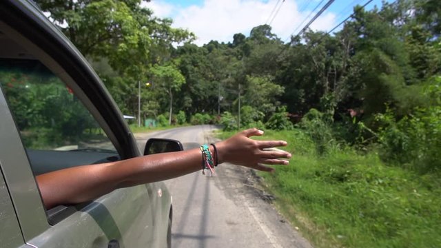 Slow Motion of Black Female Hand Outside of Car Window Enjoying in Summer Breeze on Ride Through Costa Rica Countryside