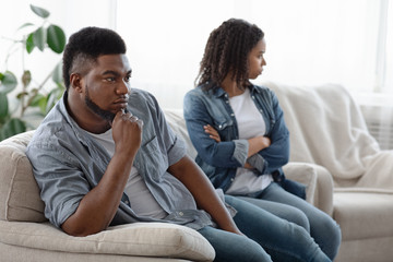 Misunderstanding In Relationship. Young black couple ignoring each other after conflict