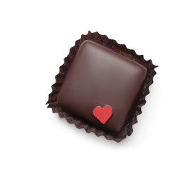 Delicious dark chocolate candy with little red heart isolated on white, top view