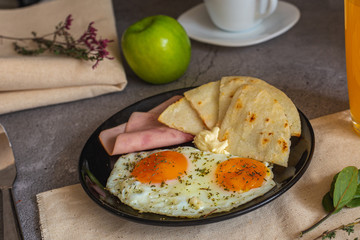Arepa paisa with eggs, ham and cream cheeseArepa paisa with eggs, ham and cream cheese (Colombian breakfast)