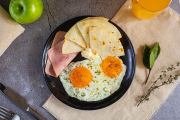 Arepa paisa with eggs, ham and cream cheese (Colombian breakfast)