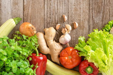 Assorted vegetables on a wooden background. Template for text, top view.