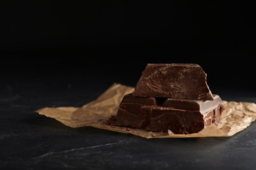 Pieces of dark chocolate on black table
