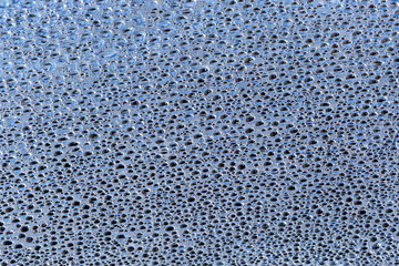 Water Drops On Blue Background.