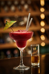 red drink ice cocktail making bar