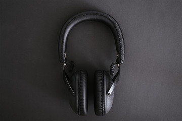 Fototapeta na wymiar Black headphones on a black background.