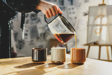 Woman pouring a cup of coffee