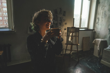 Girl drinks coffe and laughs