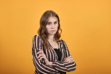 Cute Young Woman Light Brown In Striped Pink, Black Shirt On A Yellow Background, Offended Woman...