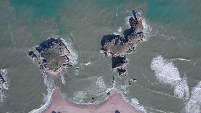 Bird's-eye view of turquoise calming waves and rocks, Black Sea Sile, Turkey 