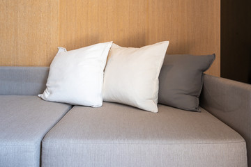 Fototapeta na wymiar Modern fabric pillows on gray cloth sofa interior in living room decoration