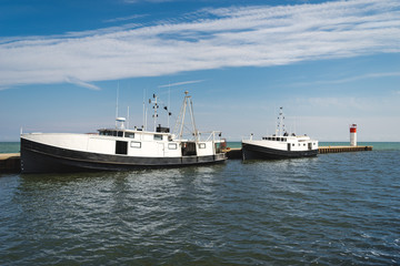 Naklejka premium Two commercial fishing boats tied up at port