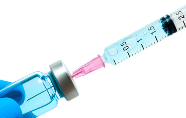 Doctor's hand holds a syringe and a blue vaccine  bottle at the hospital. Health and medical concepts