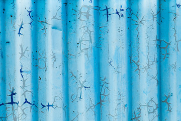 Metal curly sheets are painted in sky-blue color, old cracked paint. Abstract grunge texture. Vintage background
