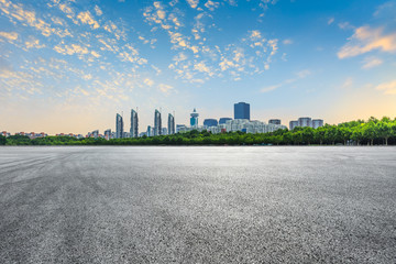 Asphalt race track road and city skyline with buildings in Shanghai at sunset.China.