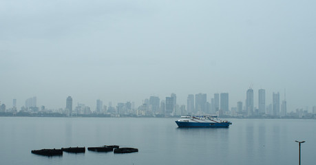 Bombay skyline with ferry in the foreground.
