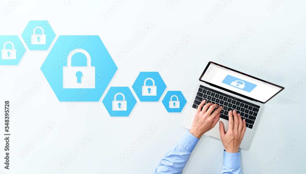 Aufkleber Computer security system and data protection system concept. Top view of business man using laptop on white background.