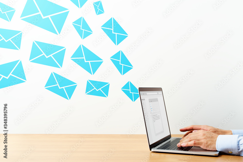 Poster business man sending and receiving email on wood table. using laptop for writing mail.