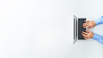 Fototapeta na wymiar Top view of businessman using laptop. Laptop with blank display. White background.