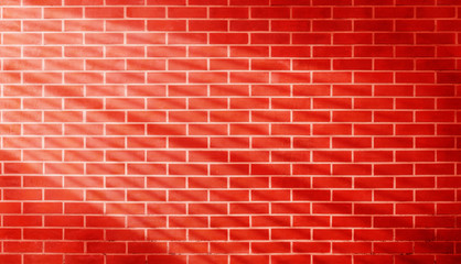 Fototapeta na wymiar Red brown vintage grunge brick wall texture background with light shading on wall.
