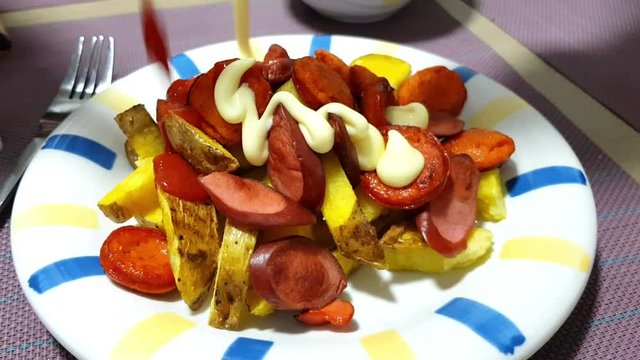 Homemade Peruvian salchipapa with mayonnaise and ketchup