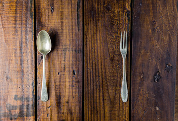 Cutlery set on a rustic wooden table. Fork, spoon. Food concept. Copy Space