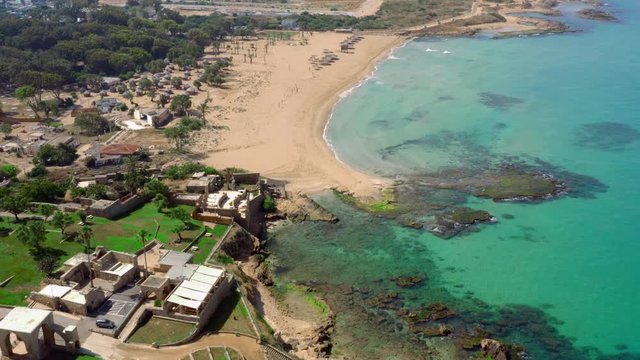 The Israeli coast of the Mediterranean Sea near the city of Nahariya. Near the Banana Beach. Aerial shot in the daytime. historic ruins and modern houses on the seashore. high-quality video UHD
