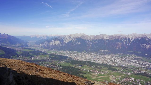 Epic panning view over the city of Innsbruck and the mountains of the alps from the viewpoint on Patscherkofel. Tyrol, Austria