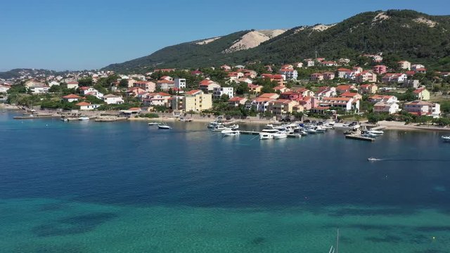 Mediterranean settlement Barbat, with natural habour and boats, surrounded with turquoise sea, Island of Rab, Croatia - Aerial View