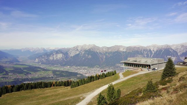 Looking over the top mountain station of the modern Patscherkofelbahn cable car above the city of Innsbruck in the mountains of the alps, Austria