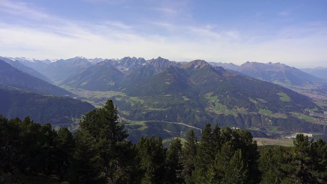 panning view slowly reveals the Inn valley near the city of Innsbruck nestled deep in the heart of the mountains of the alps in Tirol, Austria. Taken from Patscherkofel
