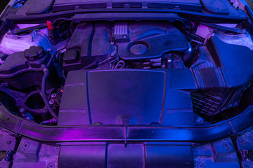 Closeup of a clean motor block in neon purple light, . Internal combustion engine.