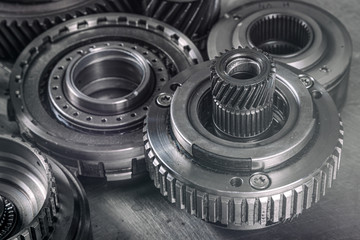 Close-up of a car gearbox. Metallic shiny gears for planetary gearshift. Industrial metal gears for Background