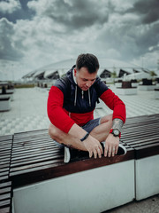 young man sitting on a bench