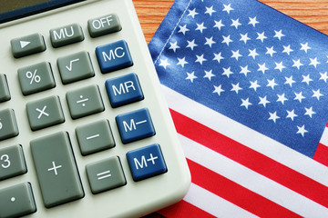 Tax reform law concept. Calculator and USA flag.