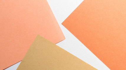 Color papers geometry shape composition background with white beige copper and brown color tones. Minimalism geometric flat lay backdrop. Top view