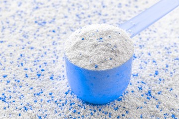 Washing detergents. White wash soap texture with cup for laundry background. Liquid powder in scoop for machine. Housekeeping and household, domestic housework cleaning service concept.