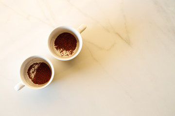 cups of coffees on white marble table in morning light