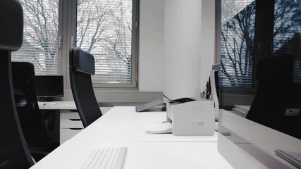 Shot of an empty desk in an office in the afternoon. Empty chairs are waiting for job applicants, office for rent or people spending their time in the homeoffice.