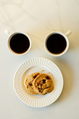 cups of coffees on white marble table in morning light