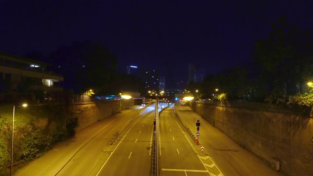 Night scenery of driving cars in Munich at normal speed. Stop and go at the Effnerplatz, wide view from a bridge, central place in the bavarian capital.