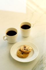 cups of coffees on white marble table in morning light