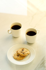cups of coffees on white marble table in morning light